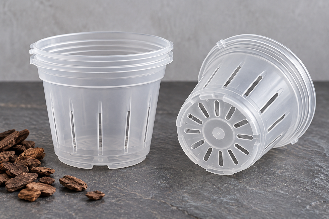 Two small pots from the set show side slots and the openings around the raised base. Bark is a styling prop.
